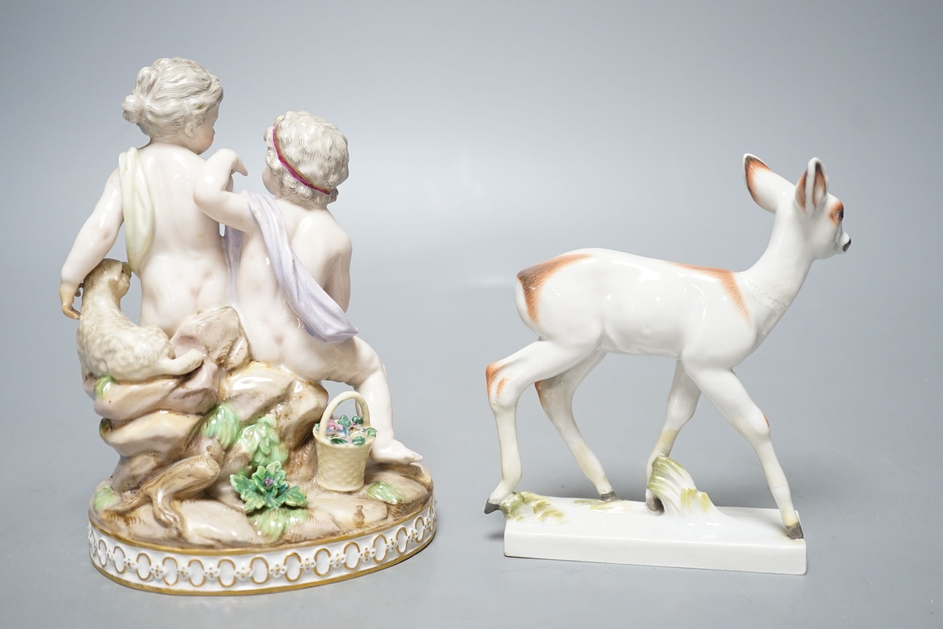A Meissen group of Amorini with a lamb and a parrot, and a Meissen model of a fawn, incised number 1490 (2)